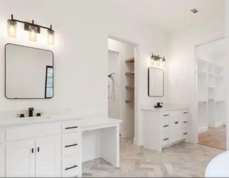 San Antonio Texas Bright, modern bathroom with two mirrors, white cabinetry, and a spacious layout.